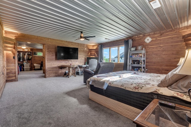 bedroom featuring wooden walls, wooden ceiling, carpet flooring, and visible vents