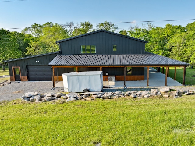 view of front of home with board and batten siding, metal roof, and a front yard