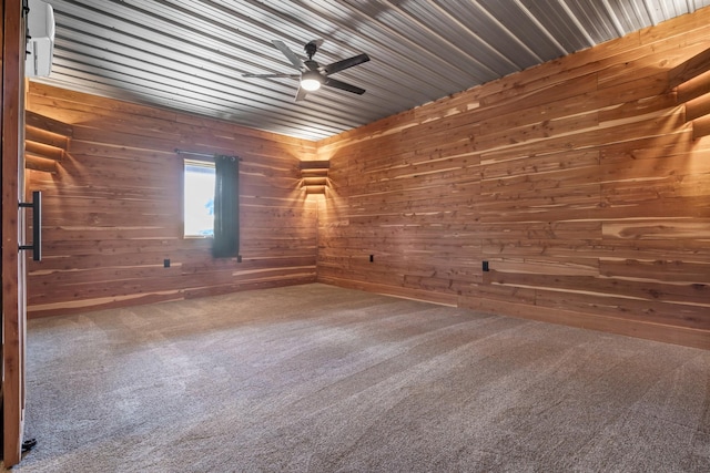 carpeted empty room with wooden walls and a ceiling fan