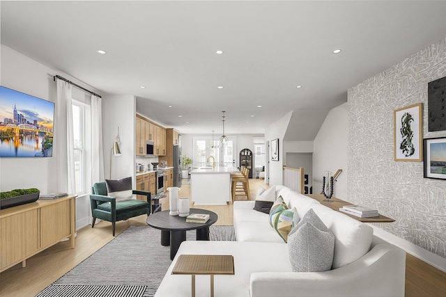 717 41st Ave N, Nashville, TN 37209 - living room with an accent wall, wallpapered walls, recessed lighting, light wood finished floors, and baseboards