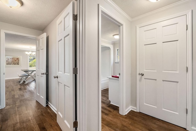 584 Lancaster Hwy, Hickman, TN 38567 - hall featuring a textured ceiling, dark wood finished floors, and a chandelier