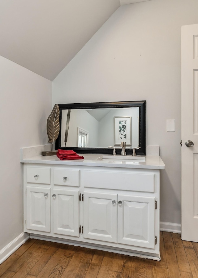 584 Lancaster Hwy, Hickman, TN 38567 - bathroom with vanity, baseboards, lofted ceiling, and wood finished floors