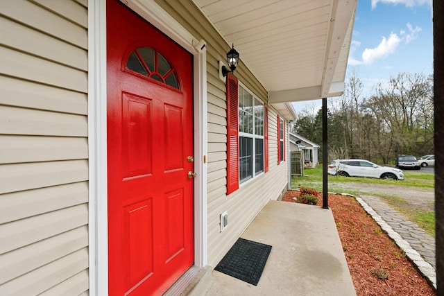 doorway to property featuring covered porch