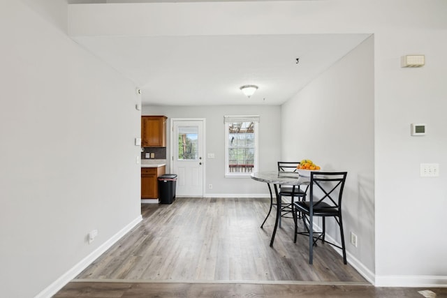 dining room featuring baseboards and wood finished floors