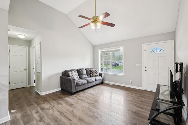 living room with visible vents, wood finished floors, baseboards, high vaulted ceiling, and a ceiling fan
