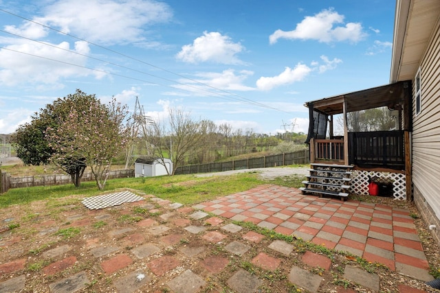 view of patio / terrace with an outbuilding, a fenced backyard, and a storage unit