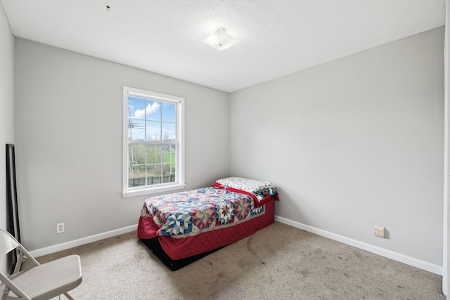 carpeted bedroom with baseboards