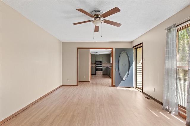 1712 Franklin Pike, Lewisburg, TN 37091 - spare room featuring ceiling fan, light wood-style floors, a textured ceiling, baseboards, and visible vents
