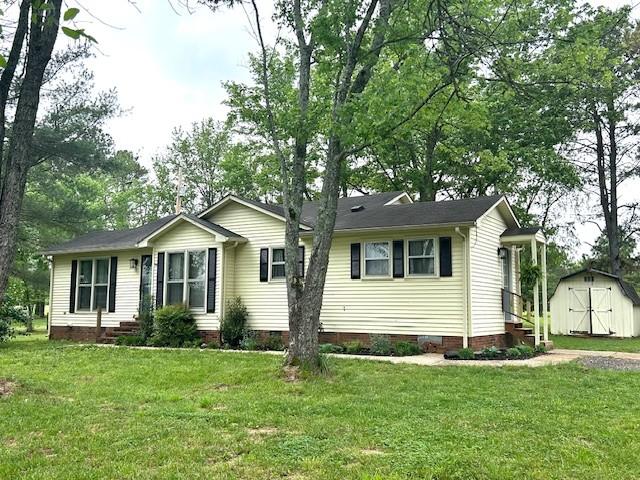 1712 Franklin Pike, Lewisburg, TN 37091 - single story home with crawl space, a front lawn, an outdoor structure, and a storage unit