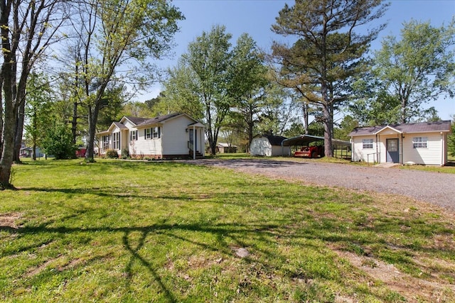 1712 Franklin Pike, Lewisburg, TN 37091 - view of yard featuring a detached carport, an outbuilding, a storage unit, and driveway