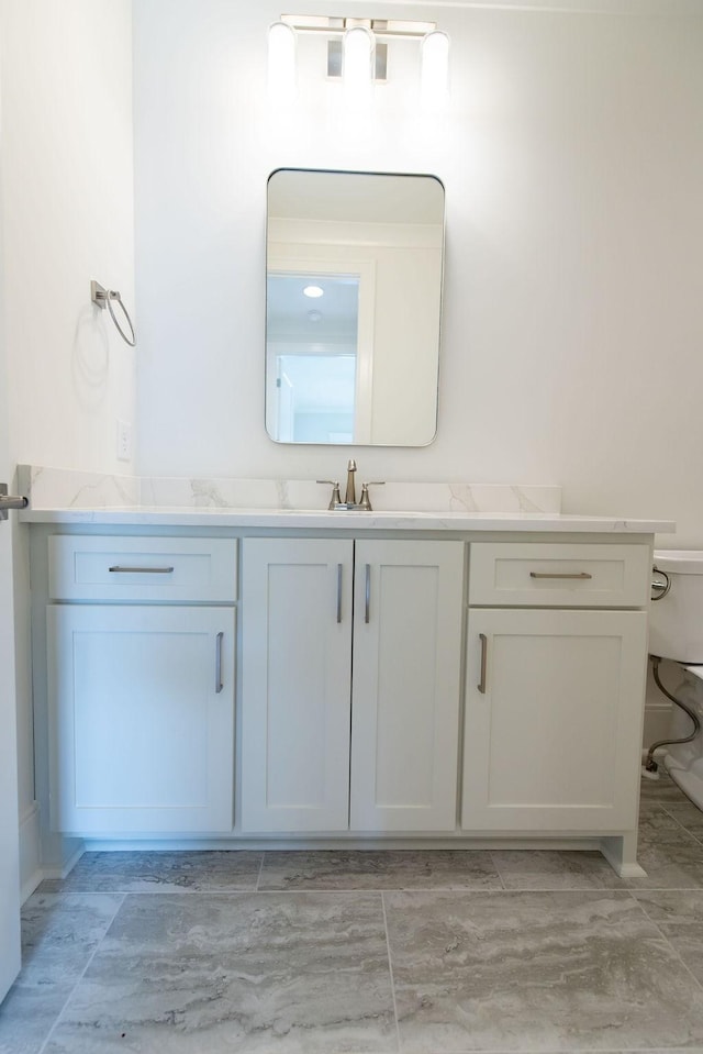 bathroom featuring toilet and vanity