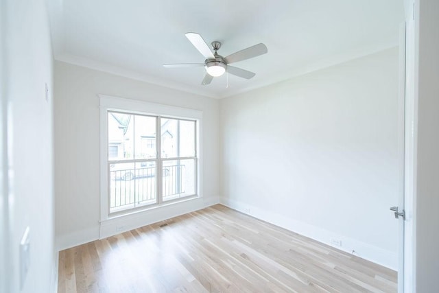 unfurnished room featuring baseboards, ceiling fan, ornamental molding, and light wood-type flooring