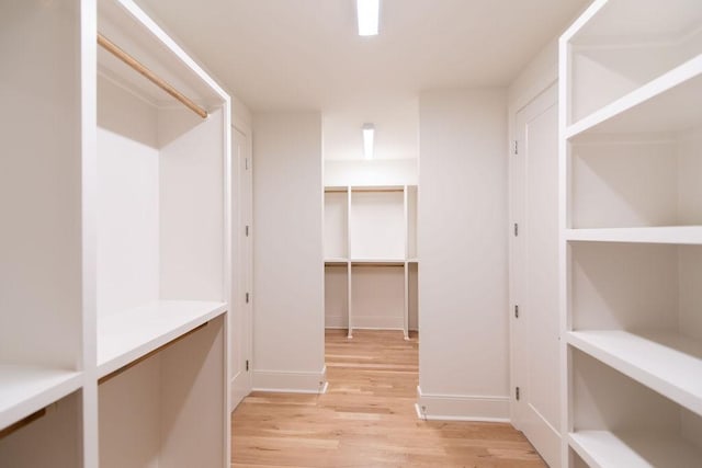 walk in closet featuring light wood finished floors