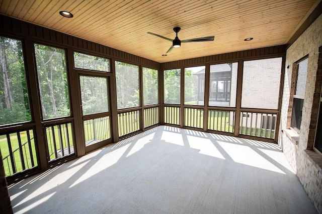 unfurnished sunroom featuring ceiling fan