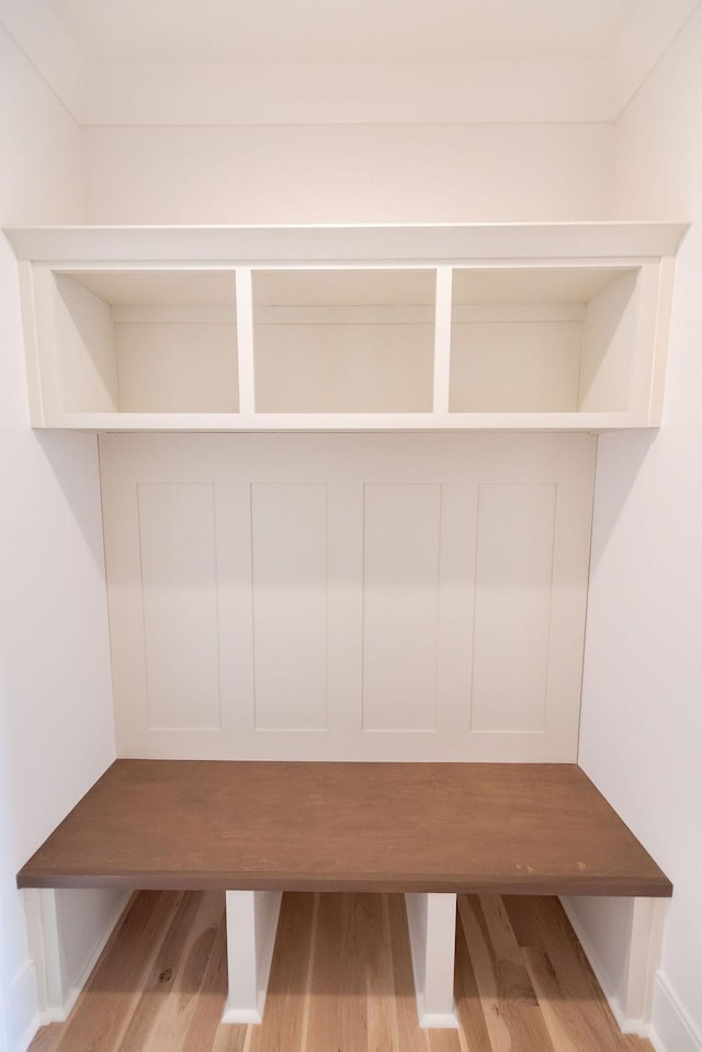 mudroom featuring baseboards and wood finished floors