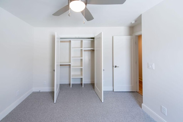 unfurnished bedroom with carpet floors, baseboards, and a closet