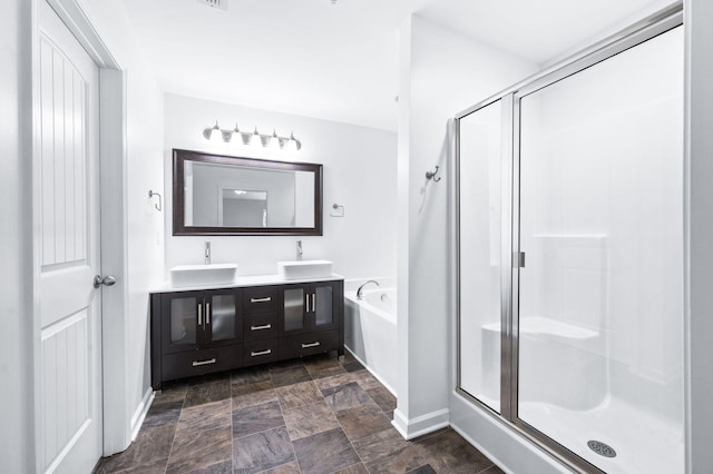 full bathroom featuring double vanity, baseboards, a sink, and a stall shower