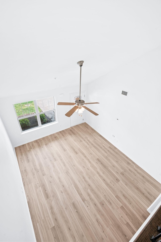 unfurnished room featuring visible vents, a ceiling fan, and wood finished floors