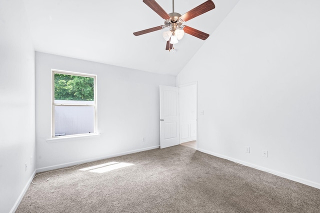 carpeted empty room featuring baseboards, ceiling fan, and high vaulted ceiling