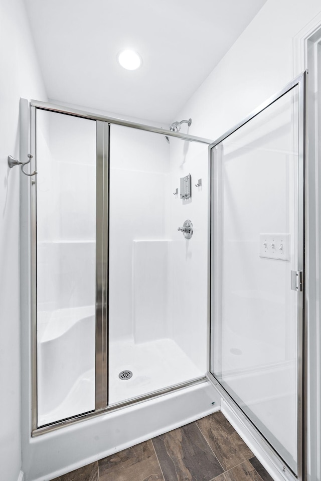 full bathroom featuring recessed lighting, wood finished floors, and a stall shower