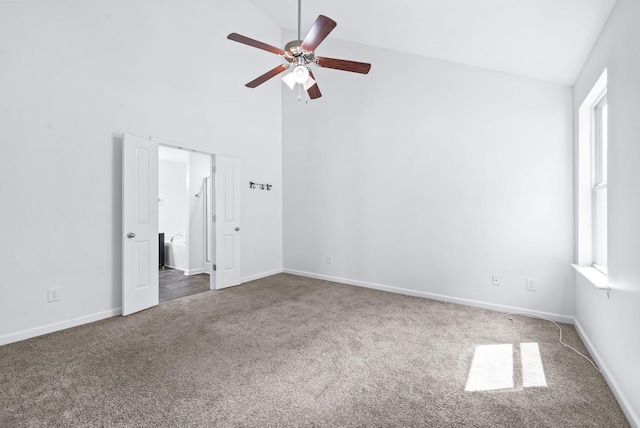 unfurnished bedroom featuring carpet floors, a ceiling fan, high vaulted ceiling, and baseboards