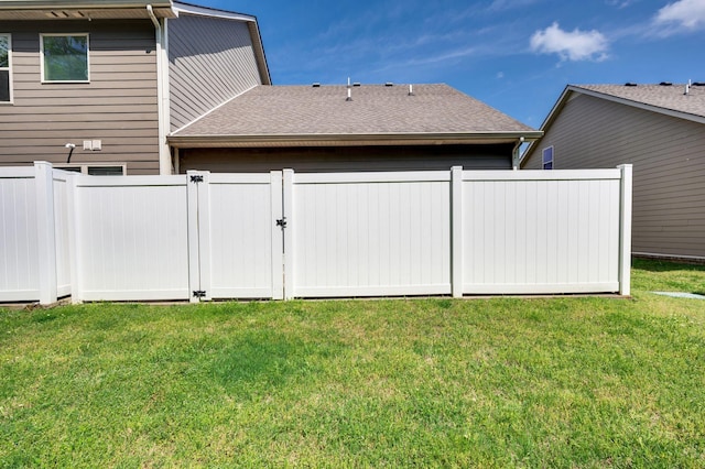 view of yard featuring fence and a gate