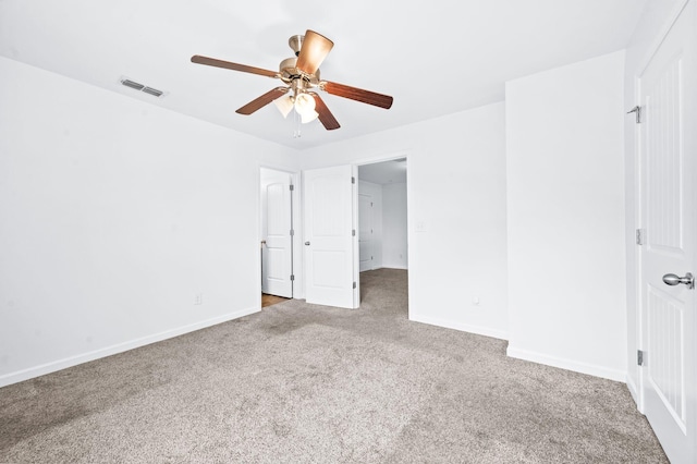unfurnished bedroom with visible vents, baseboards, carpet floors, and ceiling fan