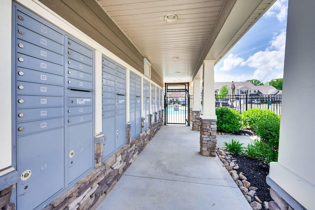 view of community featuring fence and mail area