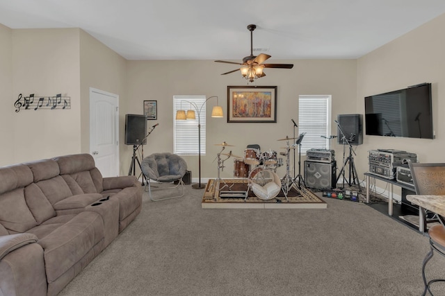 carpeted living area featuring baseboards and ceiling fan