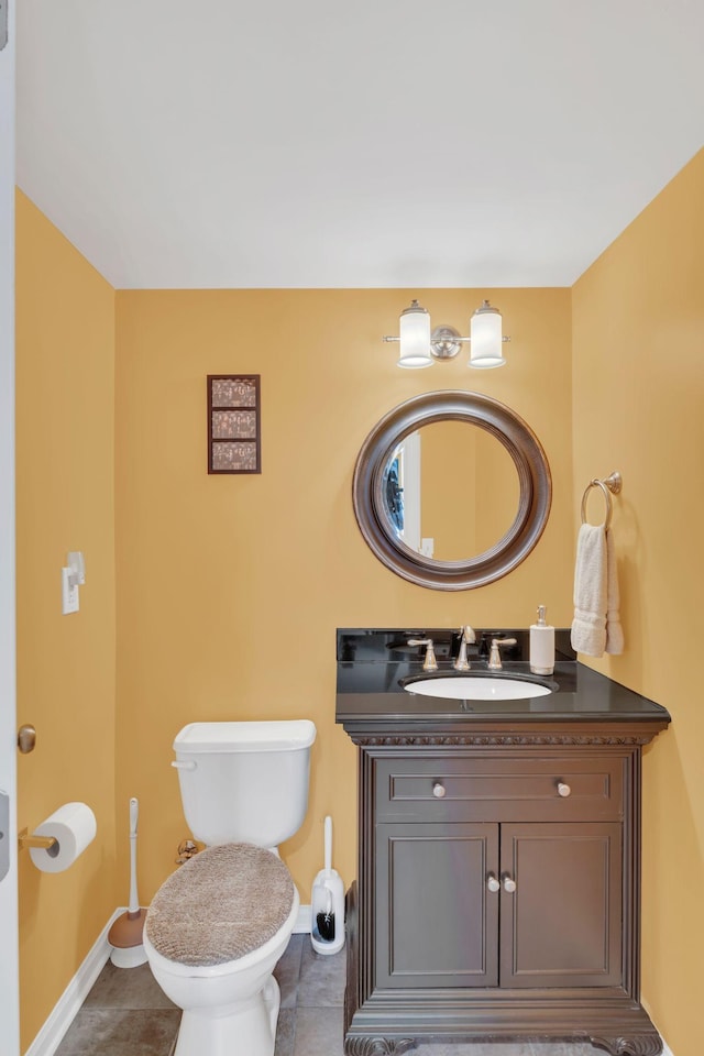 bathroom featuring toilet, baseboards, tile patterned floors, and vanity
