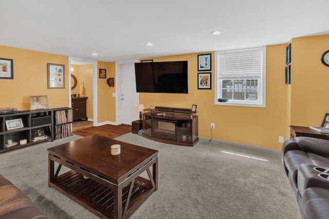 carpeted living room with recessed lighting and baseboards