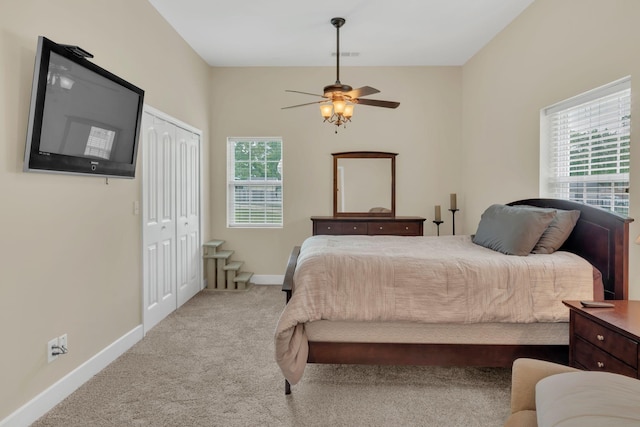 bedroom featuring carpet floors, visible vents, a closet, baseboards, and ceiling fan