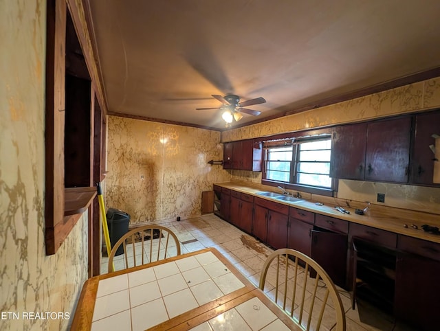 kitchen featuring a sink, ceiling fan, light tile patterned flooring, and light countertops