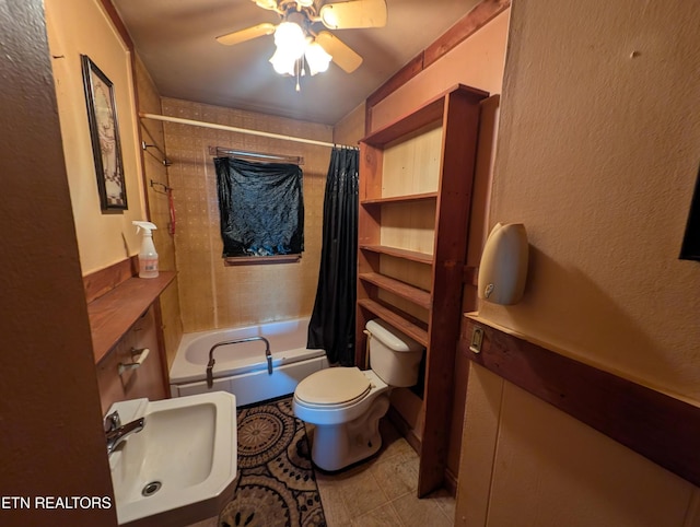 full bathroom featuring tile patterned flooring, a ceiling fan, shower / bath combination with curtain, toilet, and a sink
