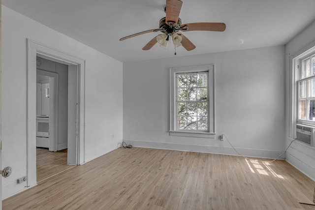 unfurnished room with ceiling fan, baseboards, and light wood-style floors