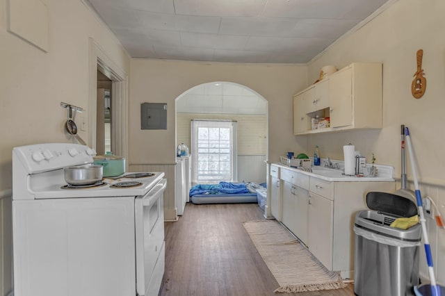 kitchen featuring electric panel, electric range, light wood-type flooring, light countertops, and ornamental molding