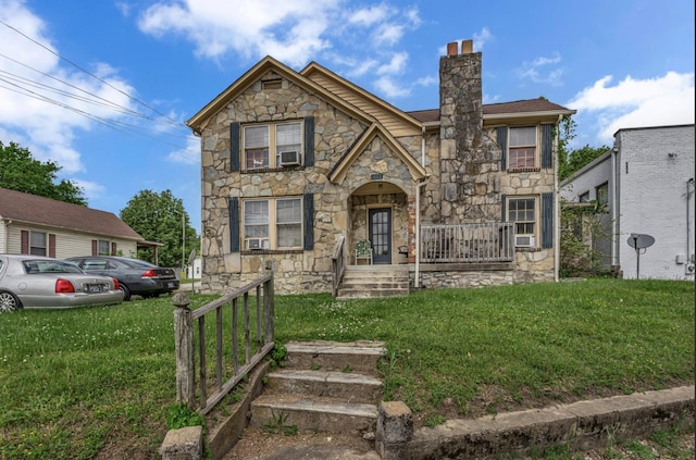 view of front of house with cooling unit, a chimney, stone siding, and a front lawn