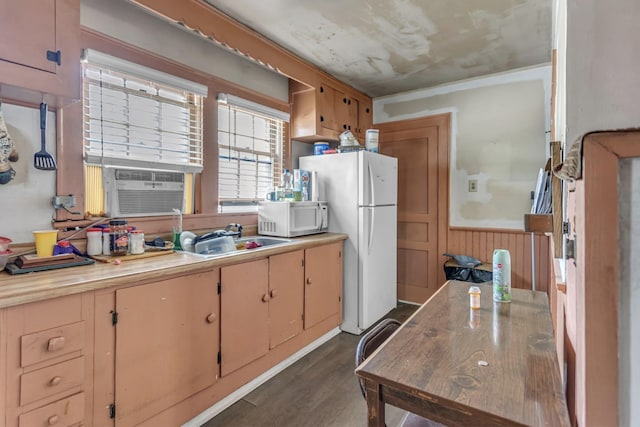 kitchen with white appliances, dark wood-type flooring, light countertops, cooling unit, and a sink