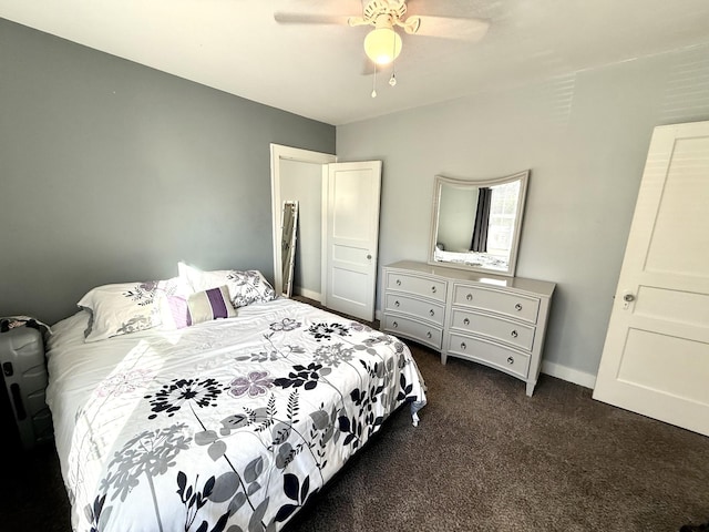 bedroom with dark colored carpet, baseboards, and ceiling fan
