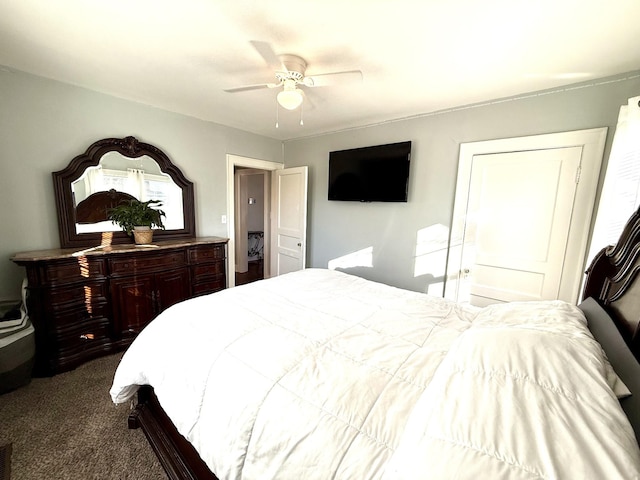 bedroom featuring a ceiling fan and dark carpet