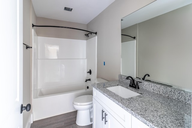 bathroom with bathing tub / shower combination, vanity, toilet, and wood finished floors