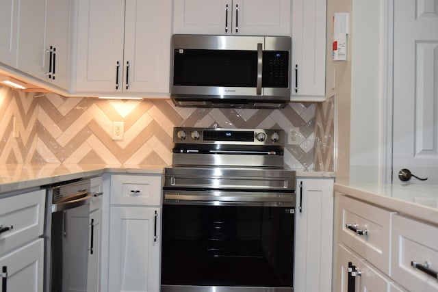 5170 Hickory Hollow Pkwy Unit 223, Antioch, TN 37013 - kitchen with backsplash, stainless steel appliances, and white cabinetry