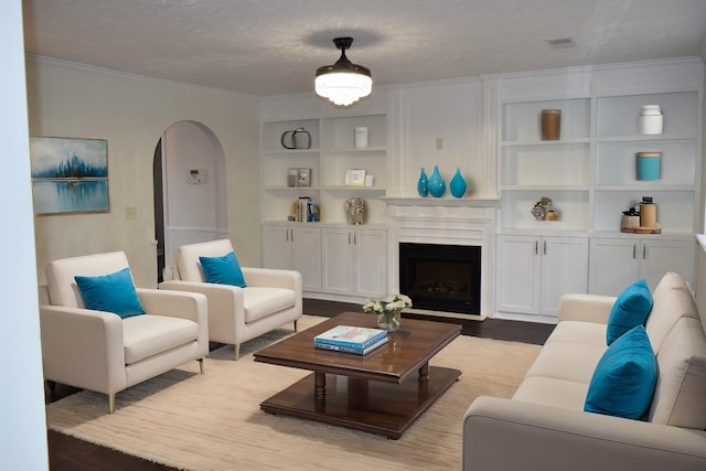 5170 Hickory Hollow Pkwy Unit 223, Antioch, TN 37013 - living room with a fireplace, arched walkways, built in features, wood finished floors, and ornamental molding