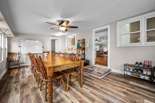 dining area featuring a ceiling fan, wood finished floors, and baseboards