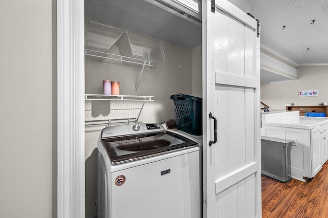 washroom with washer / dryer, dark wood-style flooring, a barn door, and crown molding