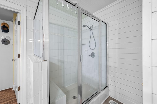 full bathroom featuring a shower stall and ornamental molding