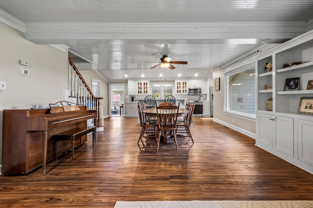 dining room featuring crown molding, stairway, ceiling fan, dark wood-type flooring, and baseboards