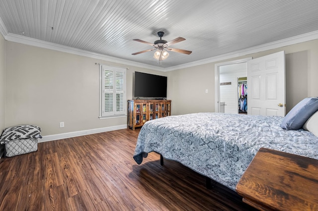 bedroom featuring baseboards, wood finished floors, crown molding, and a ceiling fan
