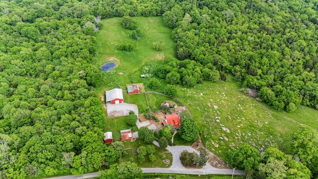 view of property location featuring a forest