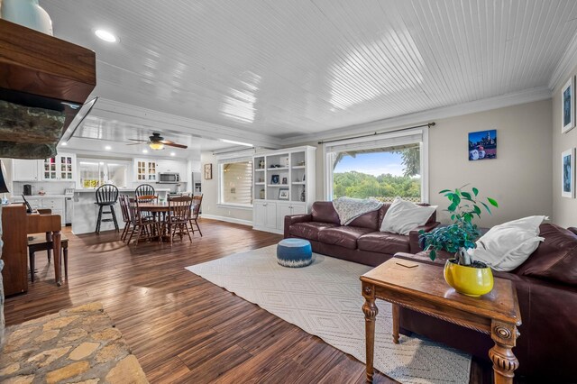 living room with crown molding, dark wood-style floors, a ceiling fan, and recessed lighting